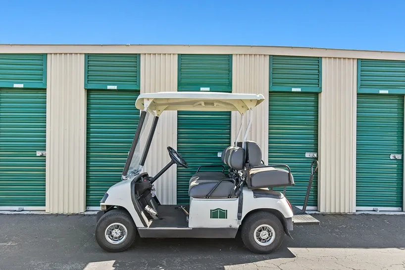 Storage lockers with golf cart parked in front.