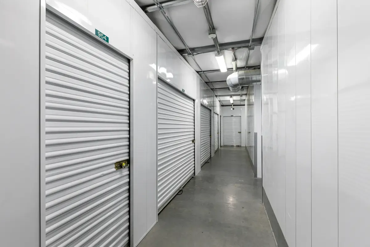 Rows of white indoor storage units.