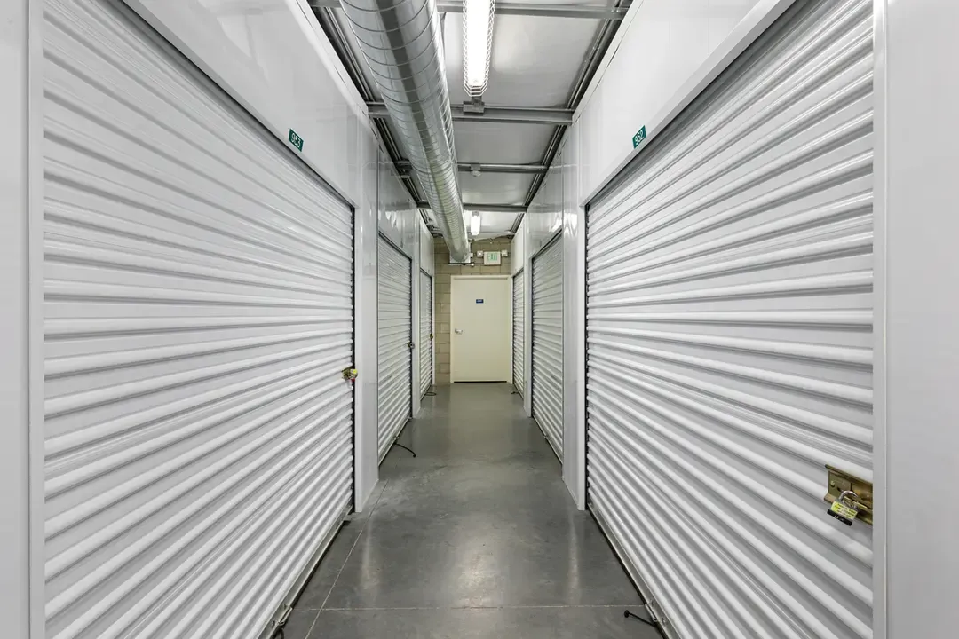 Double sided row of white indoor storage units.
