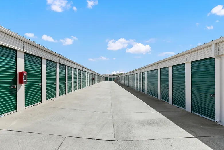 A row of green outdoor storage units.