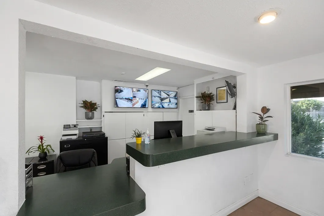 Flag, main gate, and office of a storage facility.