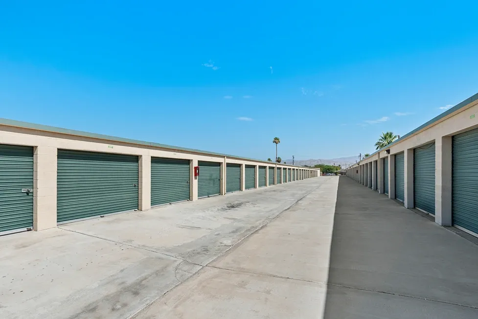 A row of outdoor green storage units
