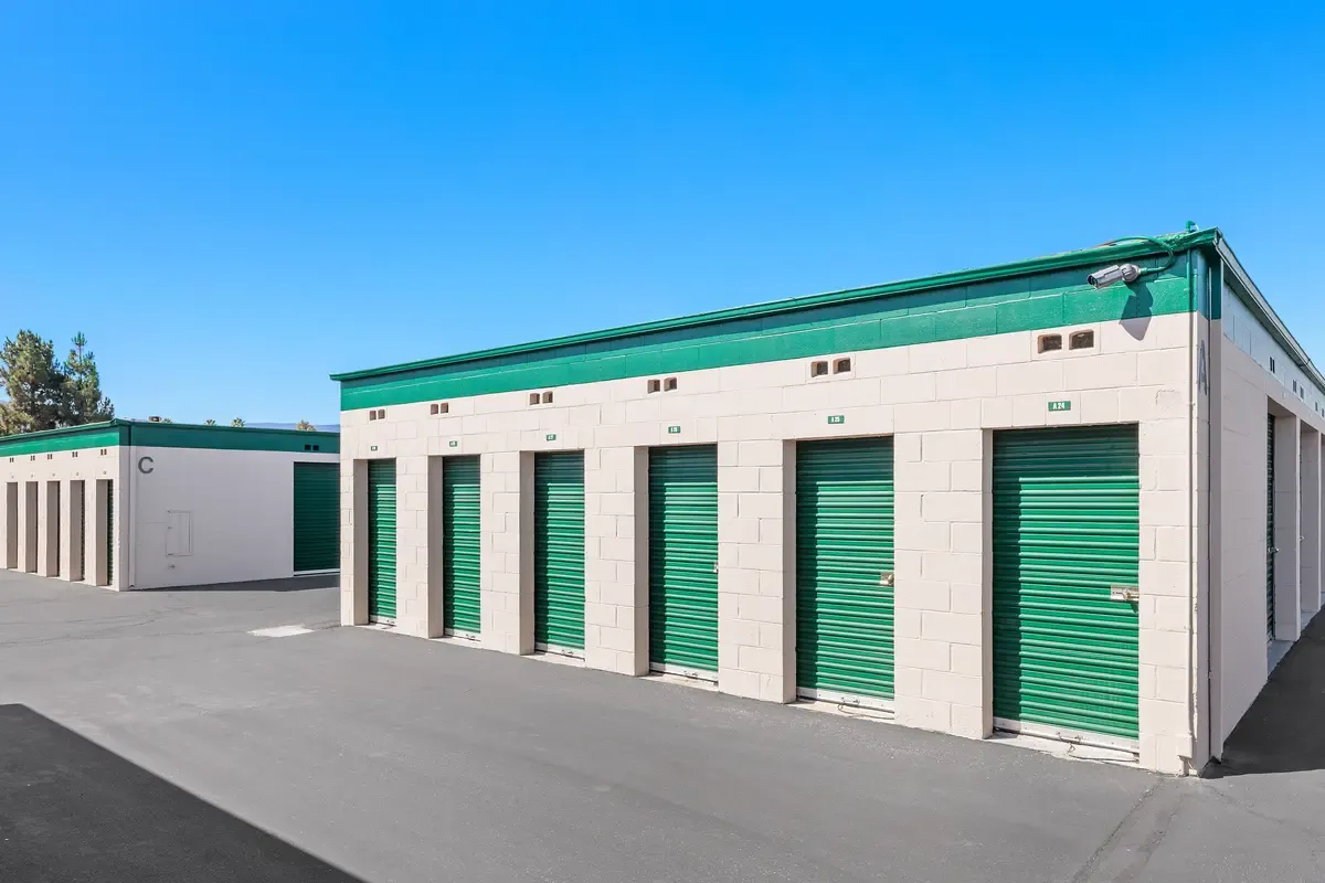 Close up of an outdoor green storage unit door.