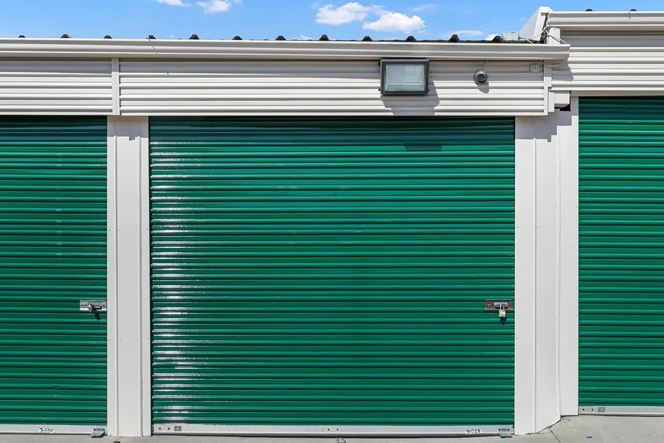 Close up of an exterior green storage unit door.