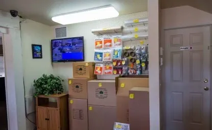 Boxes and supplies for sale at an outdoor storage facility.