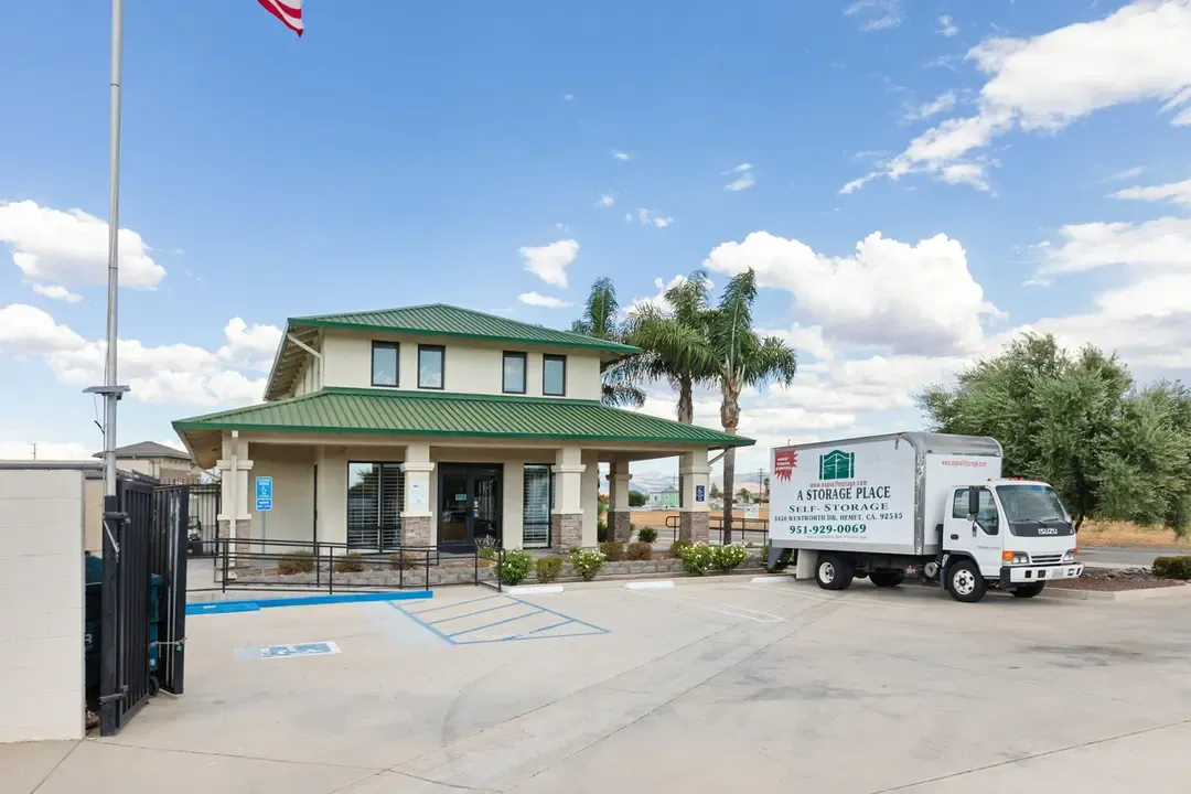 Front office building with moving truck.