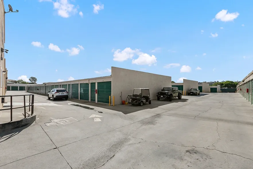 Storage units with cars parked next to them.
