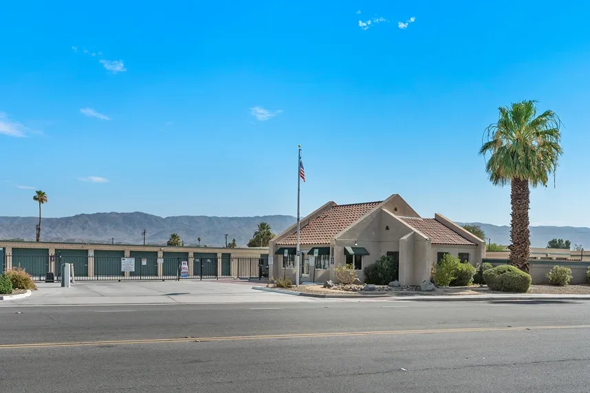 Flag, main gate, and office of a storage facility.