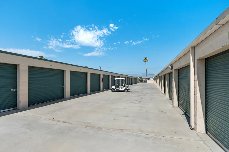 A storage place moving truck near storage units