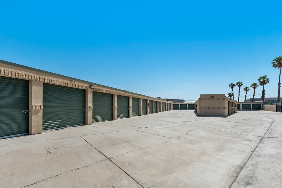 Rows of outdoor green storage units on a sunny day