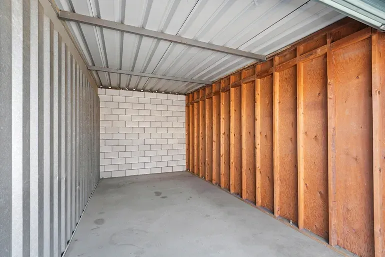 Wooden walled concrete storage unit.
