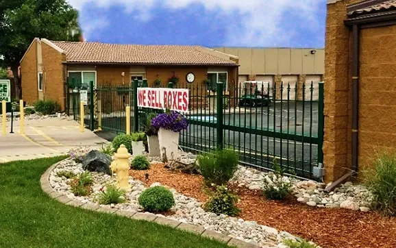 We Sell Boxes sign on a storage facility fence.